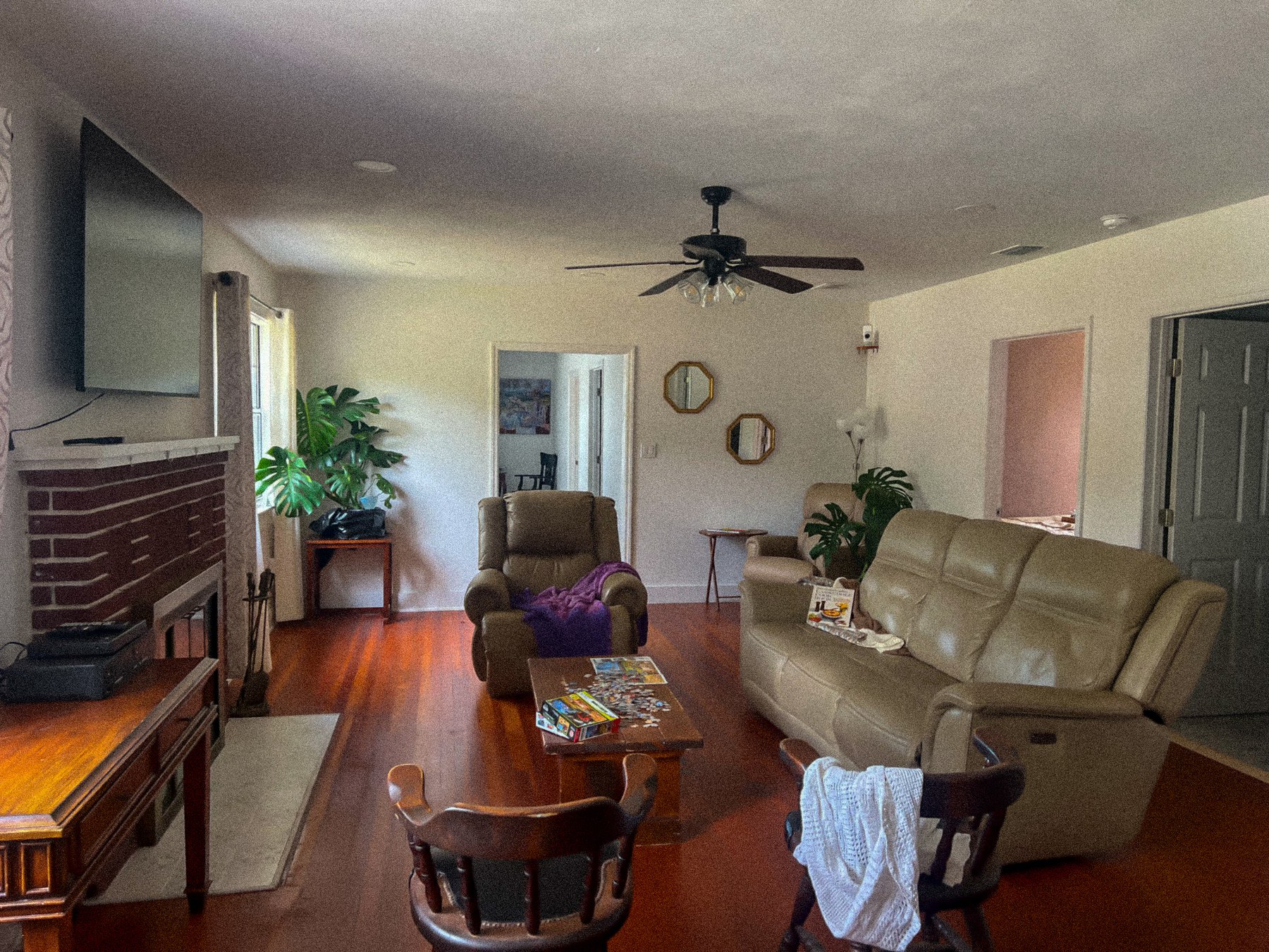 A Willow Estates living room with comfortable seating, fireplace, and television